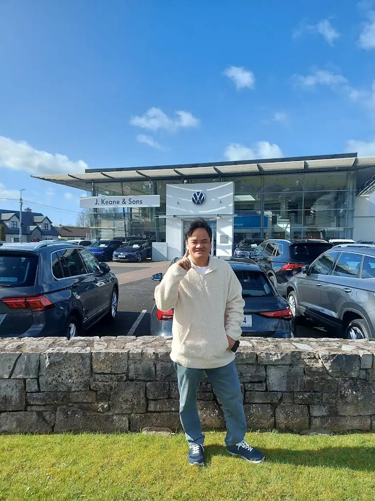 Man standing outside a motor dealership